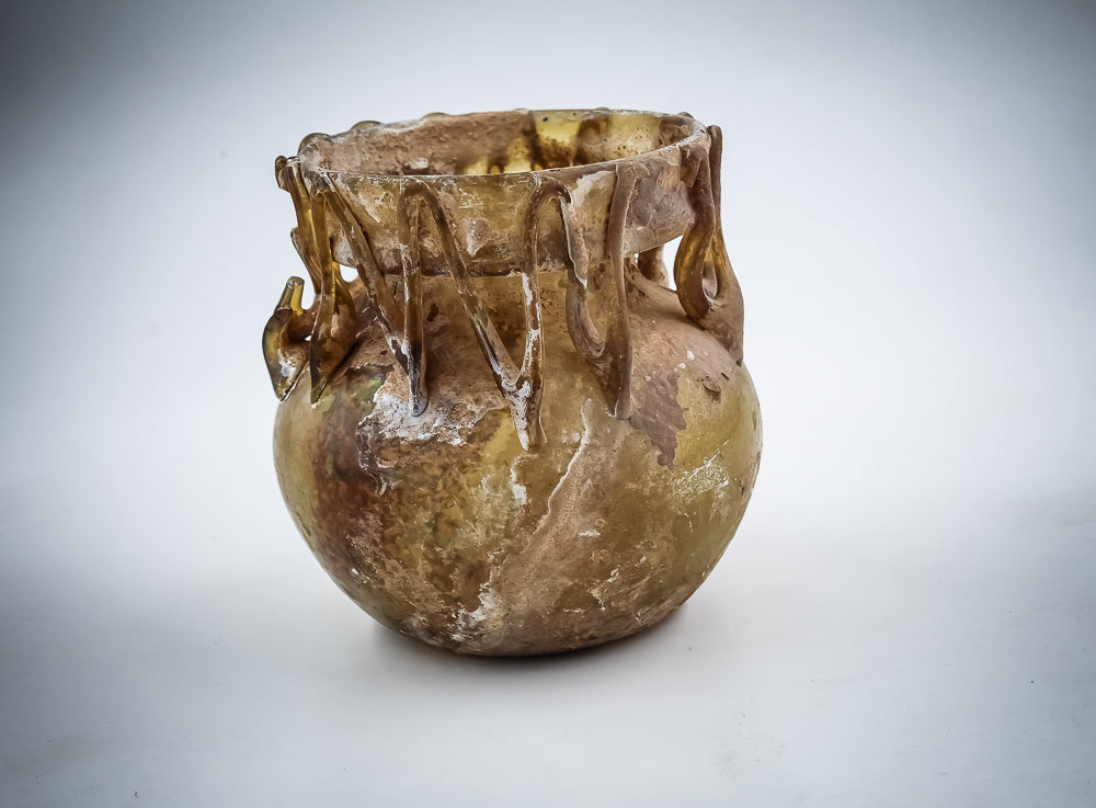 A Yellow Glass Jar With Dense Zigzag Thread Around The Neck