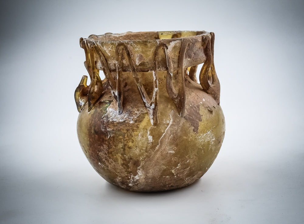 A Yellow Glass Jar With Dense Zigzag Thread Around The Neck