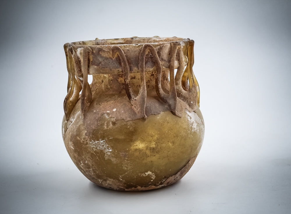 A Yellow Glass Jar With Dense Zigzag Thread Around The Neck