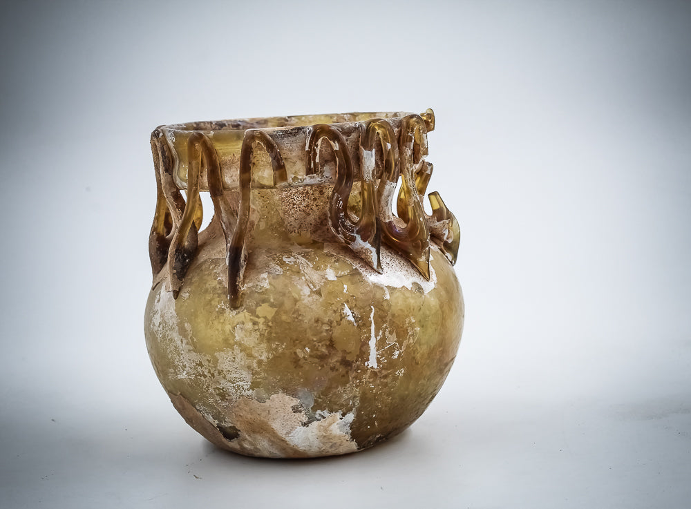 A Yellow Glass Jar With Dense Zigzag Thread Around The Neck