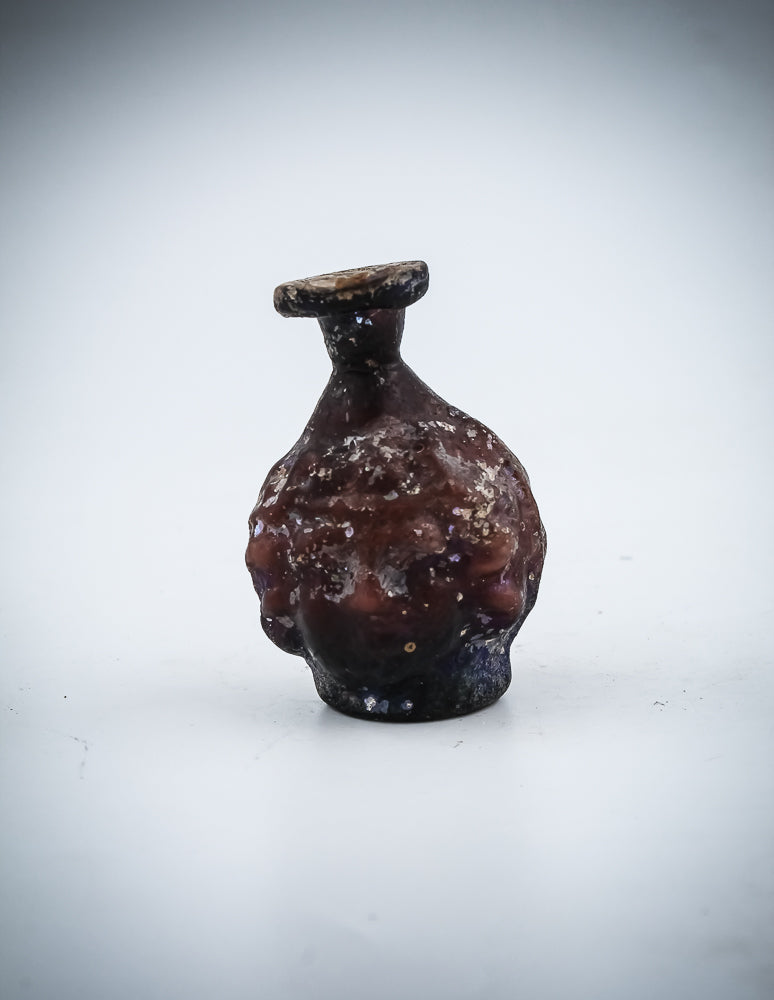 A Small  Glass Janus-Head Bottle
