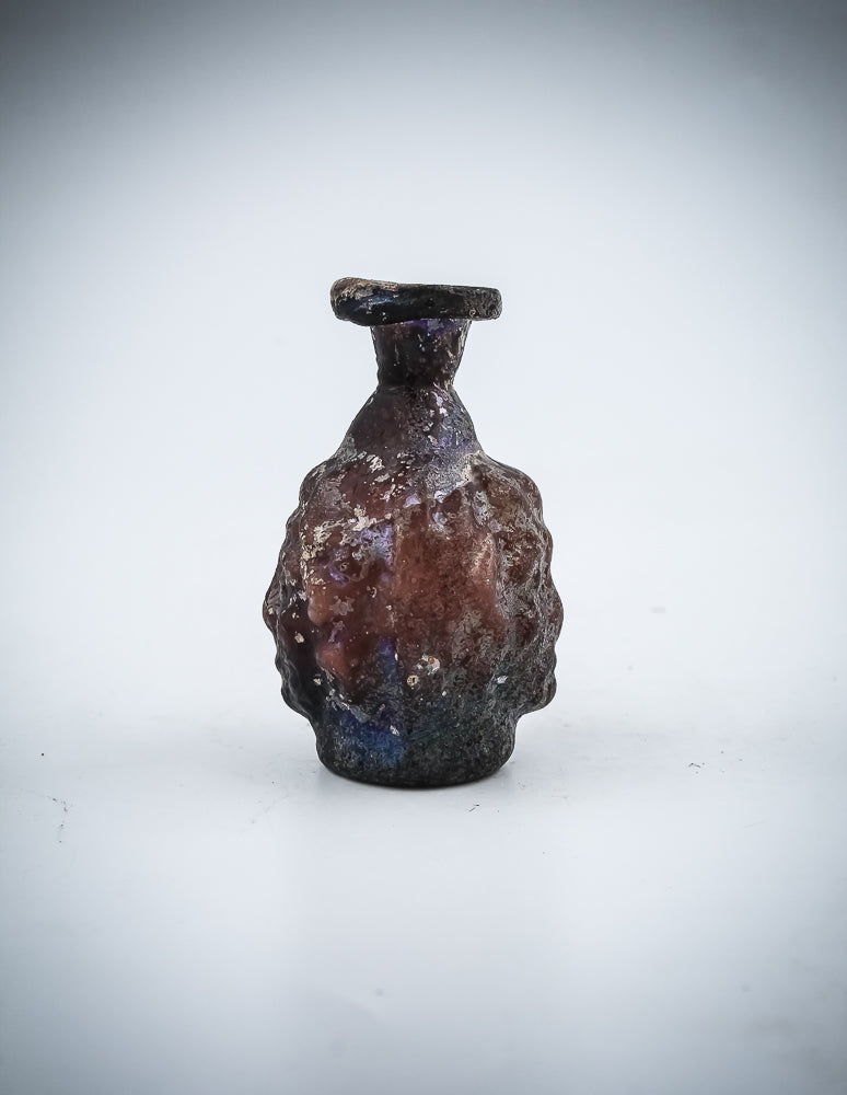 A Small  Glass Janus-Head Bottle