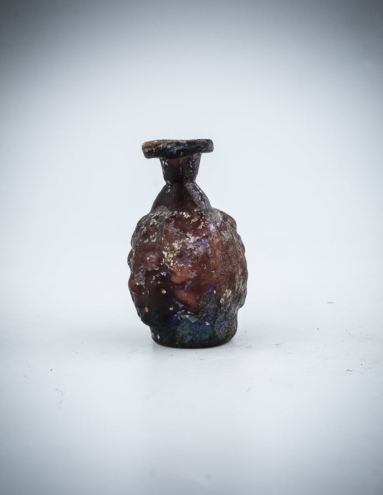 A Small  Glass Janus-Head Bottle