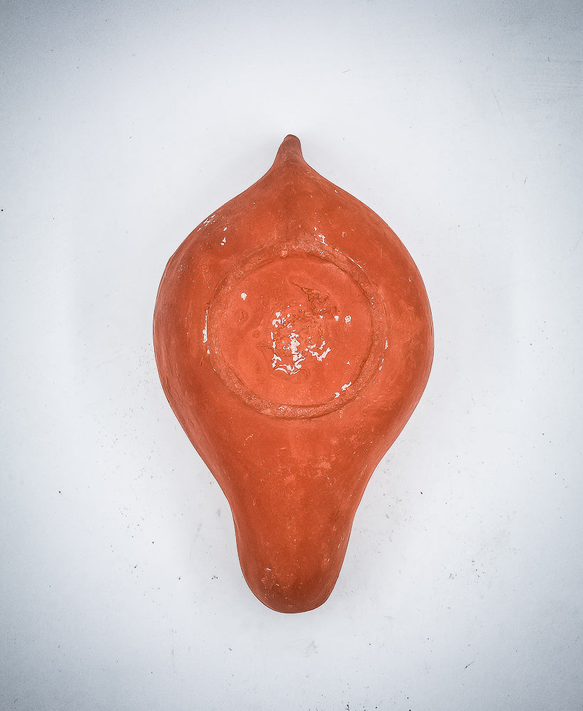 A NORTH-AFRICAN RED TERRACOTTA OIL LAMP DEPICTING A LION