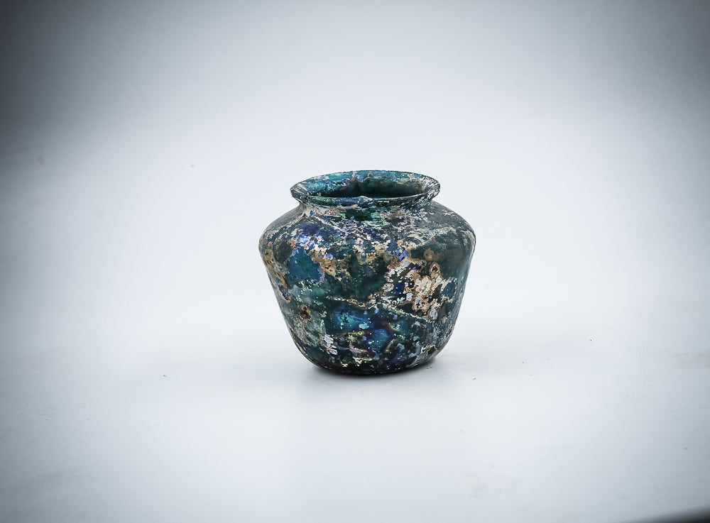 AN ISLAMIC DARK TURQUOISE GLASS JAR