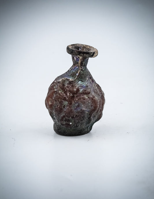 A Small  Glass Janus-Head Bottle